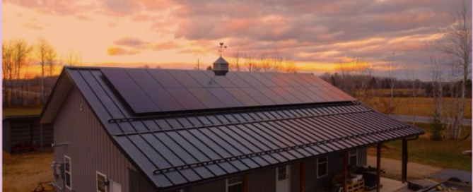 Beautiful sunset over a modern home equipped with sleek solar panels installed by Wolf River Electric, maximizing energy efficiency.